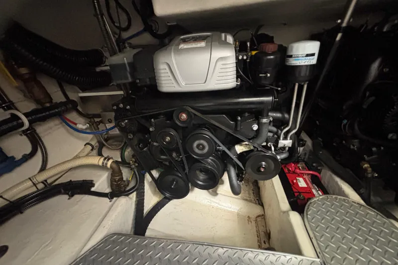 Slide: The Image of Engine compartment of a 2017 Formula 37 Performance Cruiser, showcasing mechanical components and wiring. - 52