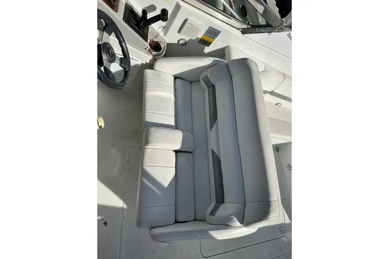 Slide: The Image of 2005 Formula 280 Sun Sport boat interior with gray seating and steering wheel. - 11