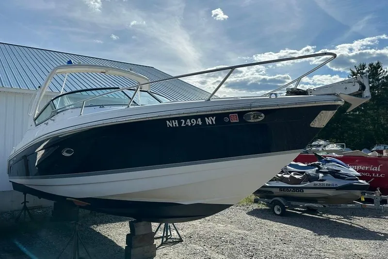 Slide: The Image of 2005 Formula 280 Sun Sport boat on stands, parked outdoors near a building. - 3