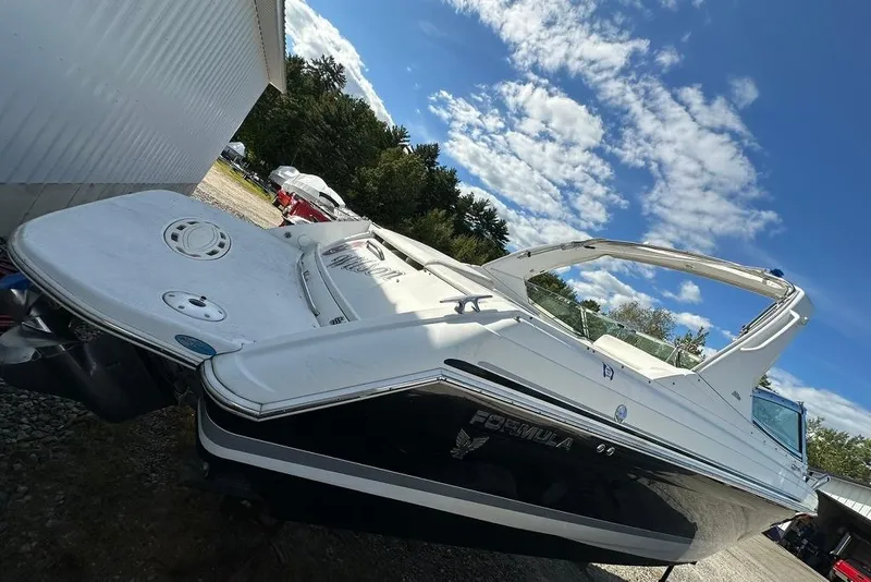 Slide: The Image of 2005 Formula 280 Sun Sport boat parked outdoors under a blue sky. - 4