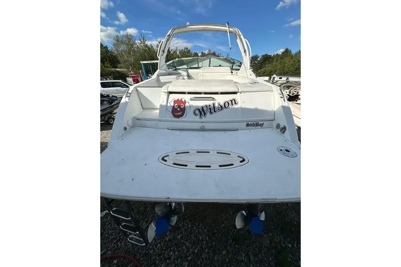 Slide: The Image of 2005 Formula 280 Sun Sport boat, rear view, on gravel with clear sky background. - 5