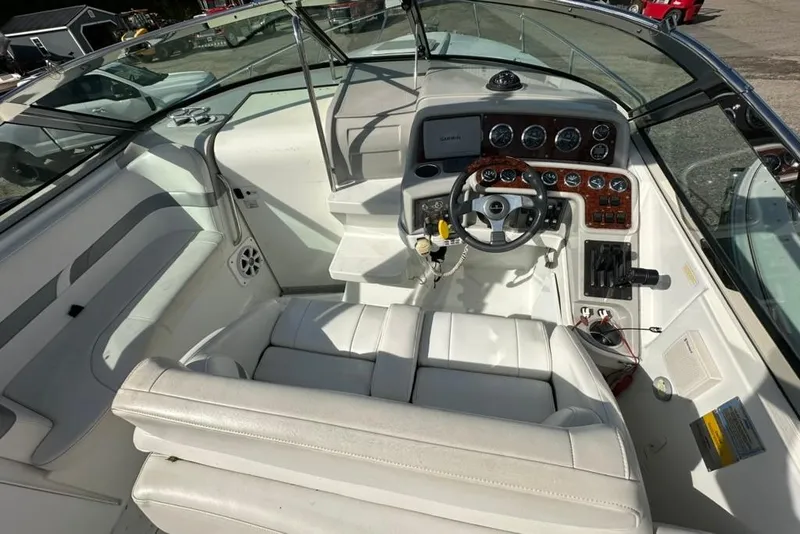 Slide: The Image of 2005 Formula 280 Sun Sport boat interior with white seating and modern dashboard controls. - 8