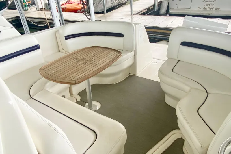 Slide: The Image of 2007 Sea Ray 38 Sundancer interior with white seating and wooden table. - 10