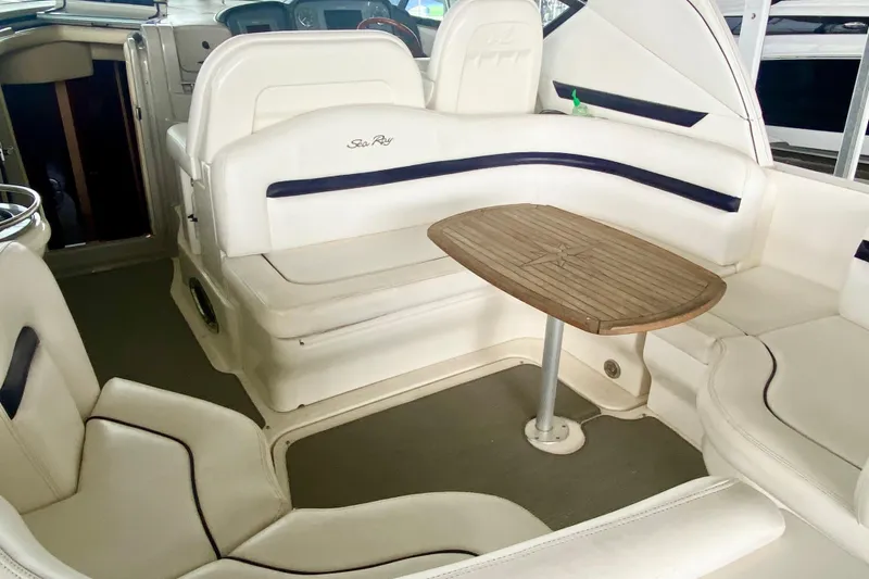 Slide: The Image of 2007 Sea Ray 38 Sundancer interior with white seating and wooden table. - 11