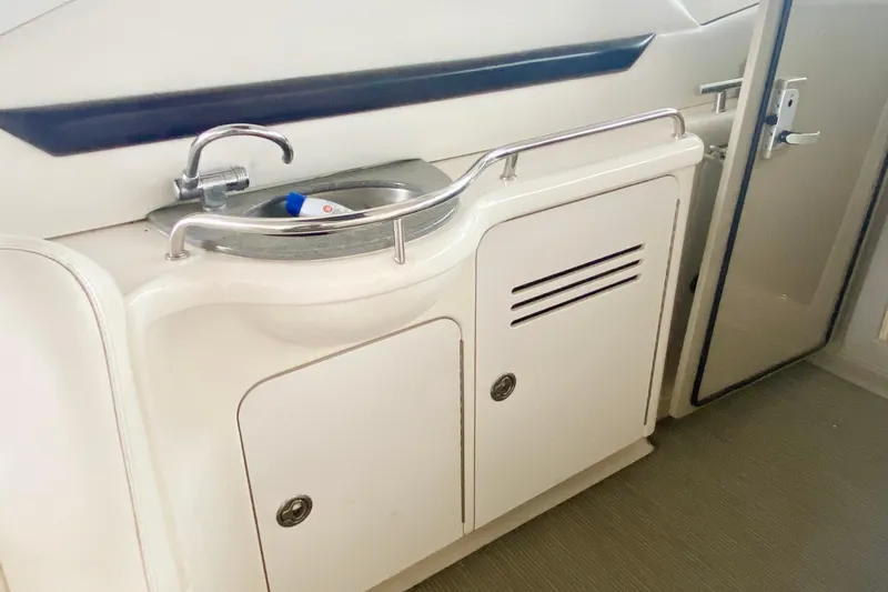 Slide: The Image of 2007 Sea Ray 38 Sundancer yacht interior with sink and storage cabinets. - 13