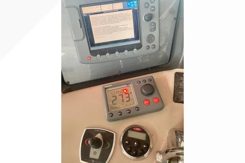 Slide: The Image of Control panel of a 2007 Sea Ray 38 Sundancer boat with navigation and thruster controls. - 19