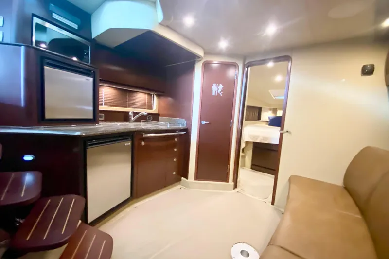 Slide: The Image of Interior of 2007 Sea Ray 38 Sundancer yacht with kitchenette and seating area. - 21