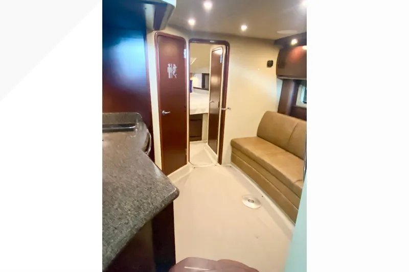 Slide: The Image of Interior of 2007 Sea Ray 38 Sundancer yacht with sofa and cabin door. - 24