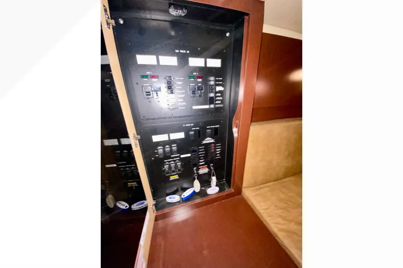 Slide: The Image of Electrical panel inside 2007 Sea Ray 38 Sundancer yacht, featuring control switches and indicators. - 25