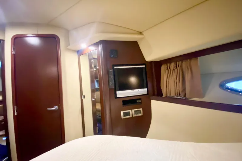 Slide: The Image of Interior cabin of 2007 Sea Ray 38 Sundancer with TV and wood accents. - 27