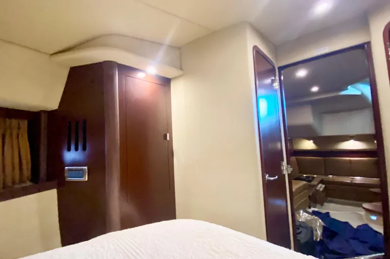 Slide: The Image of Interior cabin of 2007 Sea Ray 38 Sundancer yacht, featuring wood paneling and cozy seating. - 28