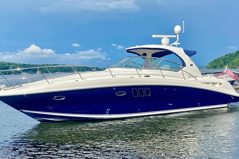 Slide: The Image of 2007 Sea Ray 38 Sundancer yacht on calm water, clear sky background. - 3