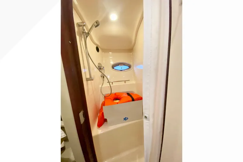 Slide: The Image of Shower area in 2007 Sea Ray 38 Sundancer yacht with porthole and life jacket. - 30