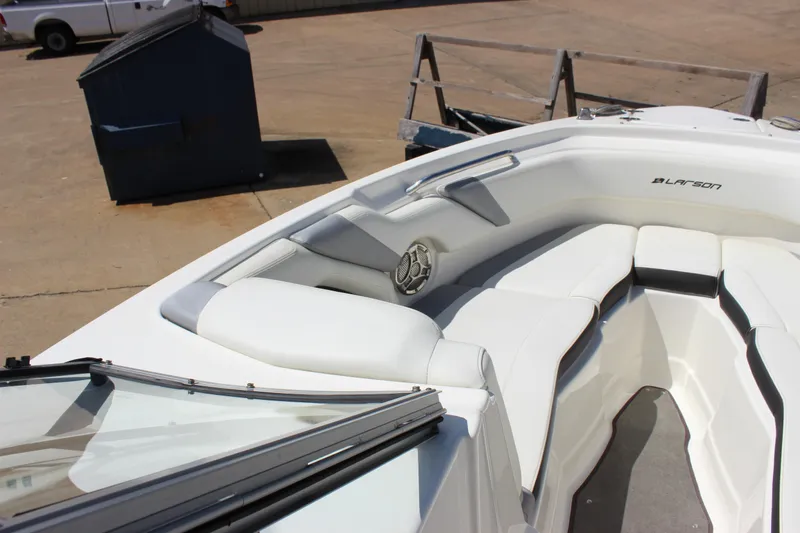 Slide: The Image of 2014 Larson LXi 258 IO boat interior with white seating and speaker. - 13