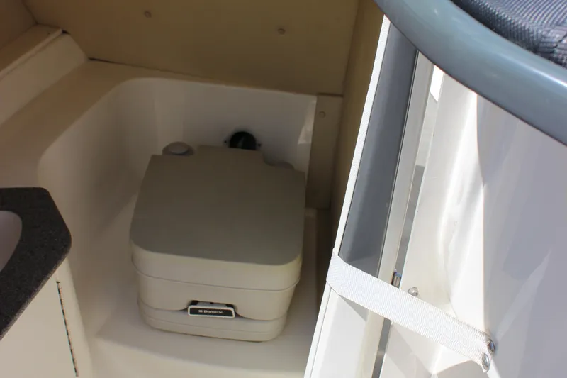 Slide: The Image of 2014 Larson LXi 258 IO boat interior with portable toilet. - 18