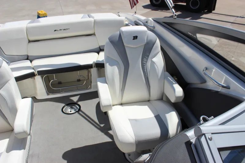 Slide: The Image of 2014 Larson LXi 258 IO boat interior with white seating and modern design. - 21