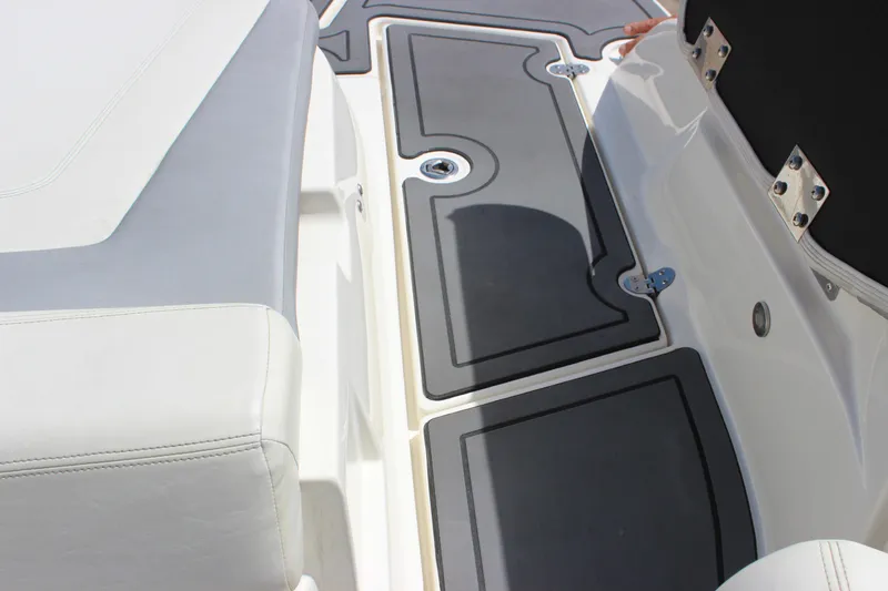 Slide: The Image of 2014 Larson LXi 258 IO boat interior with cushioned seating and non-slip flooring. - 30
