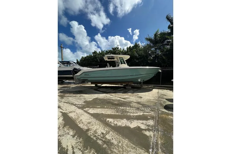 The Image of 2022 Boston Whaler 330 Outrage boat on display under a clear blue sky. - 1