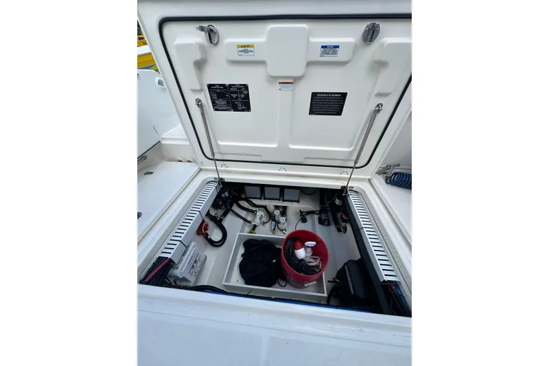 Slide: The Image of 2022 Boston Whaler 330 Outrage storage compartment with equipment and supplies. - 10