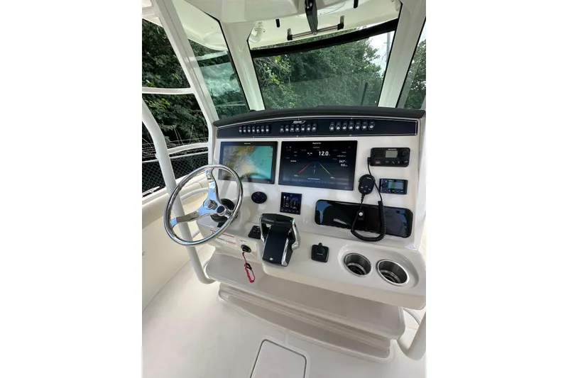 Slide: The Image of 2022 Boston Whaler 330 Outrage helm with advanced navigation and control systems. - 3