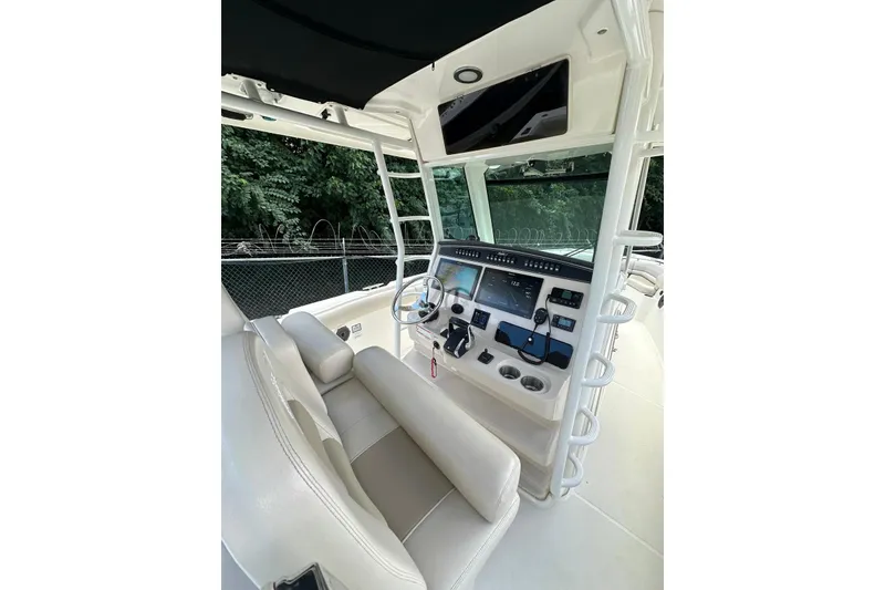 Slide: The Image of 2022 Boston Whaler 330 Outrage helm with modern controls and comfortable seating. - 8