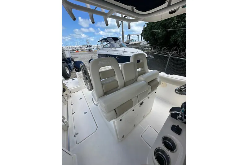 Slide: The Image of 2022 Boston Whaler 330 Outrage boat interior with seating and control panel. - 9