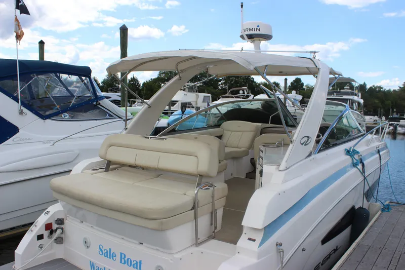 The Image of 2014 Regal 32 Express boat docked, featuring spacious seating and modern design. - 0