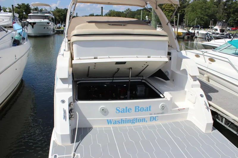 Slide: The Image of 2014 Regal 32 Express boat docked, open engine compartment, "Sale Boat" text, Washington, DC. - 10