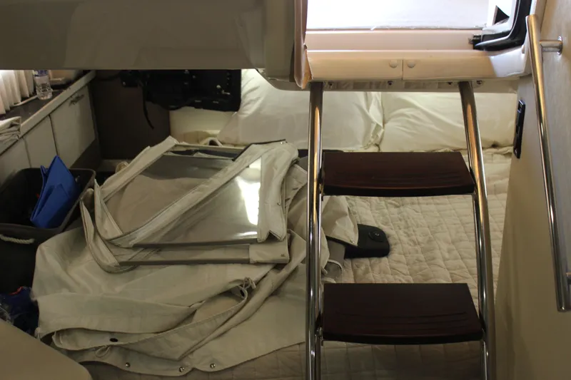 Slide: The Image of Interior cabin of 2014 Regal 32 Express boat with ladder and bedding. - 11