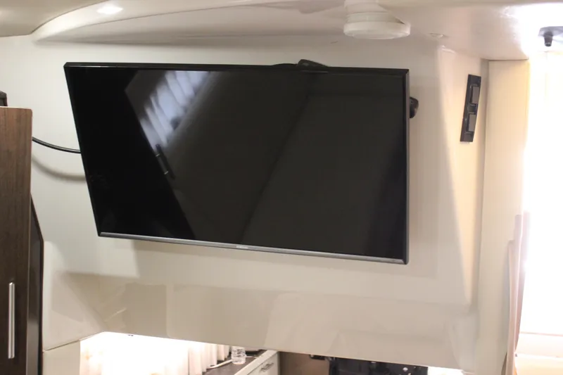Slide: The Image of Flat-screen TV mounted inside 2014 Regal 32 Express boat cabin. - 12