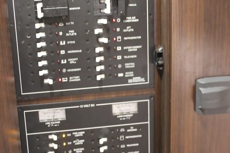 Slide: The Image of Electrical control panel on a 2014 Regal 32 Express boat, featuring various switches and indicators. - 15