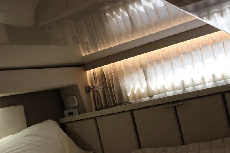 Slide: The Image of Interior cabin of 2014 Regal 32 Express yacht with soft lighting and curtains. - 30