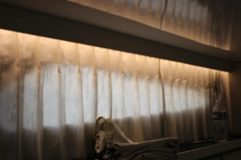 Slide: The Image of Interior view of 2014 Regal 32 Express with soft lighting and curtains. - 31