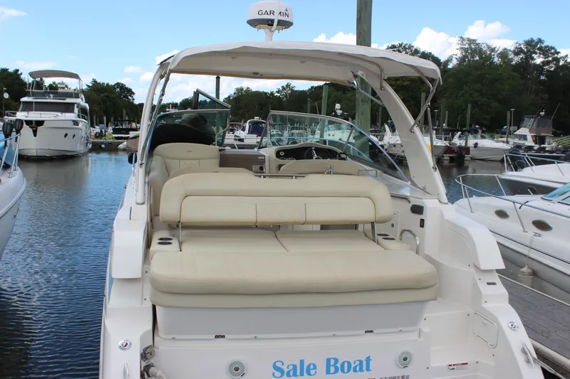 Slide: The Image of 2014 Regal 32 Express boat docked, featuring spacious seating and modern design. - 32