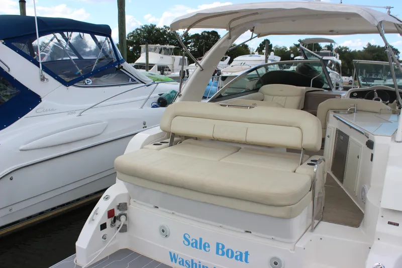Slide: The Image of 2014 Regal 32 Express boat with beige seating at a marina. - 34