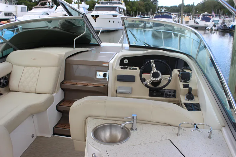 Slide: The Image of 2014 Regal 32 Express boat interior with steering wheel and seating at marina. - 35
