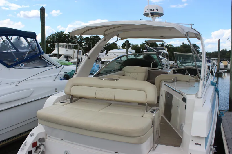 Slide: The Image of 2014 Regal 32 Express boat docked, featuring spacious seating and modern amenities. - 36
