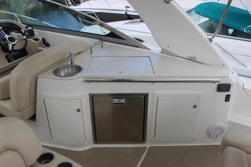 Slide: The Image of 2014 Regal 32 Express boat interior with sink, countertop, and storage cabinets. - 40