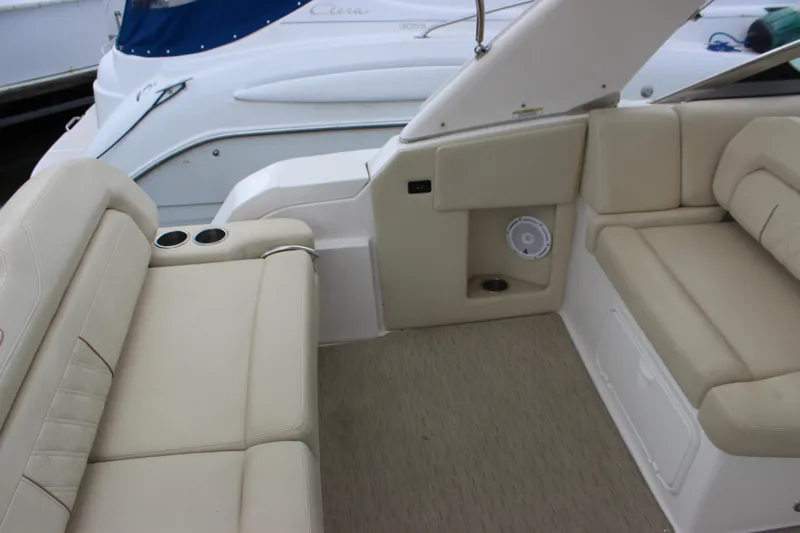 Slide: The Image of 2014 Regal 32 Express boat interior with beige seating and cup holders. - 45