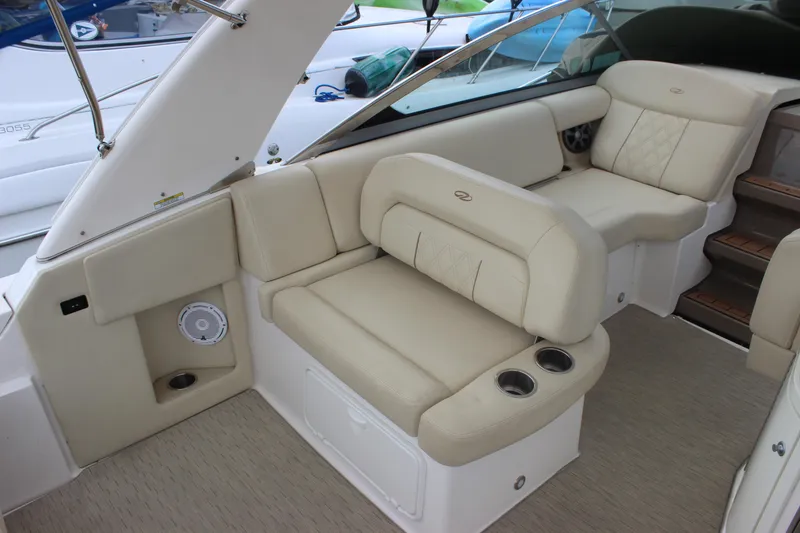 Slide: The Image of 2014 Regal 32 Express boat interior with beige seating and cup holders. - 46