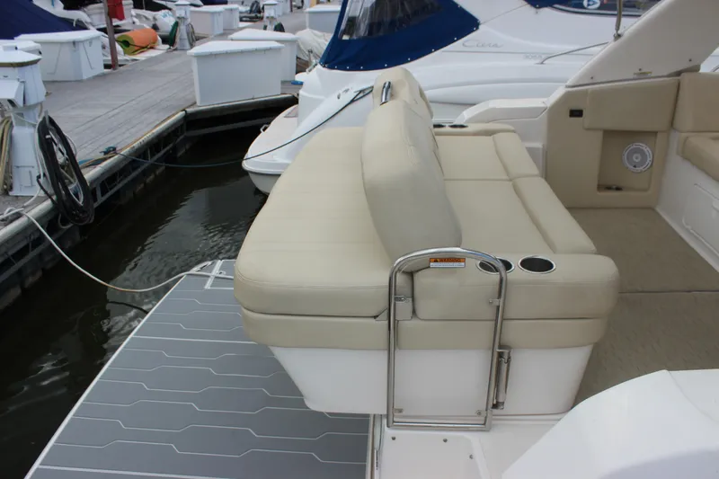 Slide: The Image of 2014 Regal 32 Express boat with beige seating and swim platform at marina. - 50