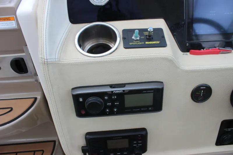 Slide: The Image of Control panel of 2014 Regal 32 Express boat with audio system and spotlight controls. - 53