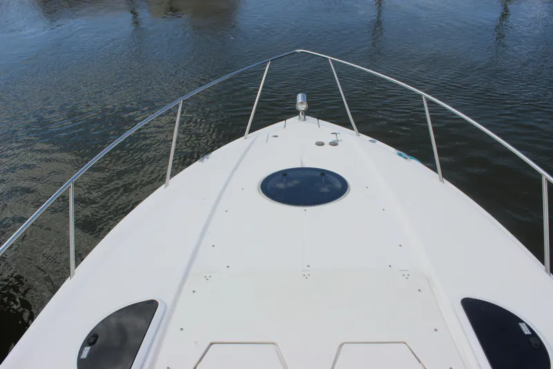 Slide: The Image of Bow view of 2014 Regal 32 Express boat on calm water. - 60