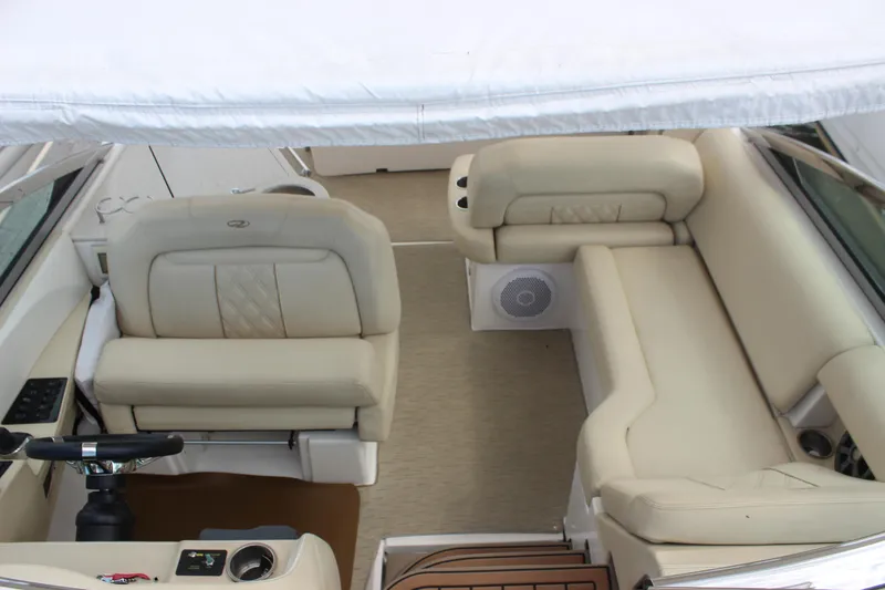 Slide: The Image of 2014 Regal 32 Express boat interior with beige seating and steering area. - 65