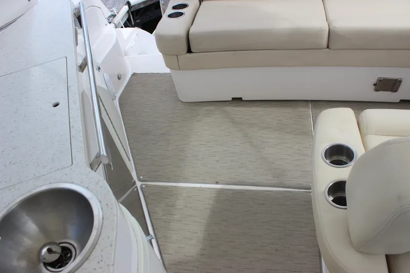 Slide: The Image of 2014 Regal 32 Express boat interior with beige seating and cup holders. - 68
