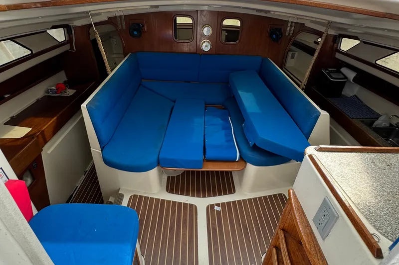 Slide: The Image of Interior of 2008 Gemini 105Mc sailboat with blue seating and wooden accents. - 16