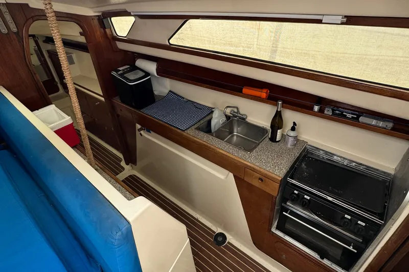 Slide: The Image of 2008 Gemini 105Mc yacht interior kitchen with sink, stove, and wooden cabinetry. - 19