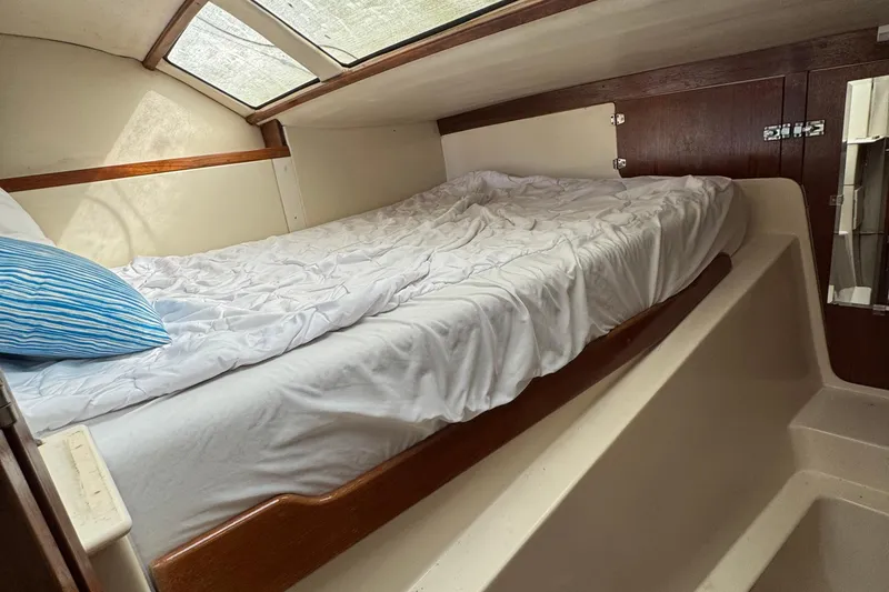Slide: The Image of Cozy cabin interior of 2008 Gemini 105Mc sailboat with bed and skylight. - 21
