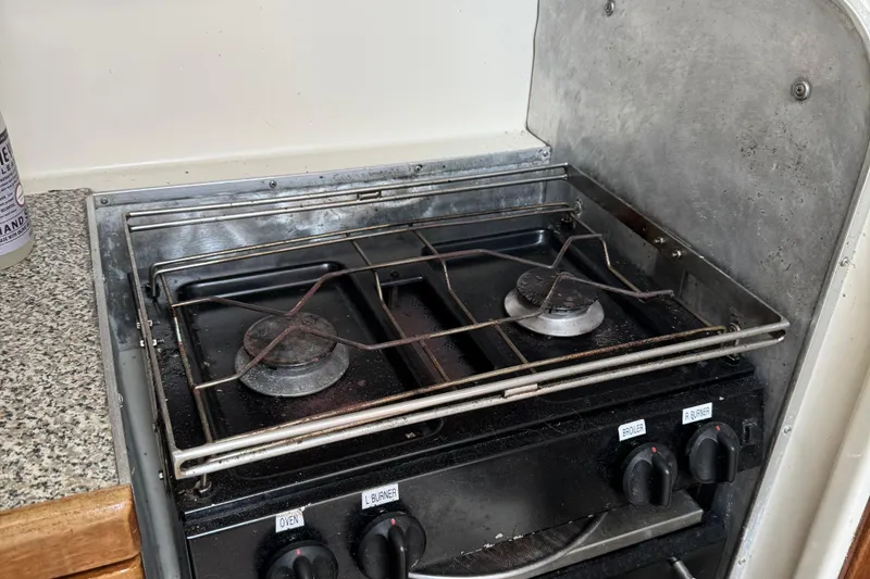 Slide: The Image of Two-burner stove in a 2008 Gemini 105Mc boat kitchen, with metal grates and control knobs. - 23