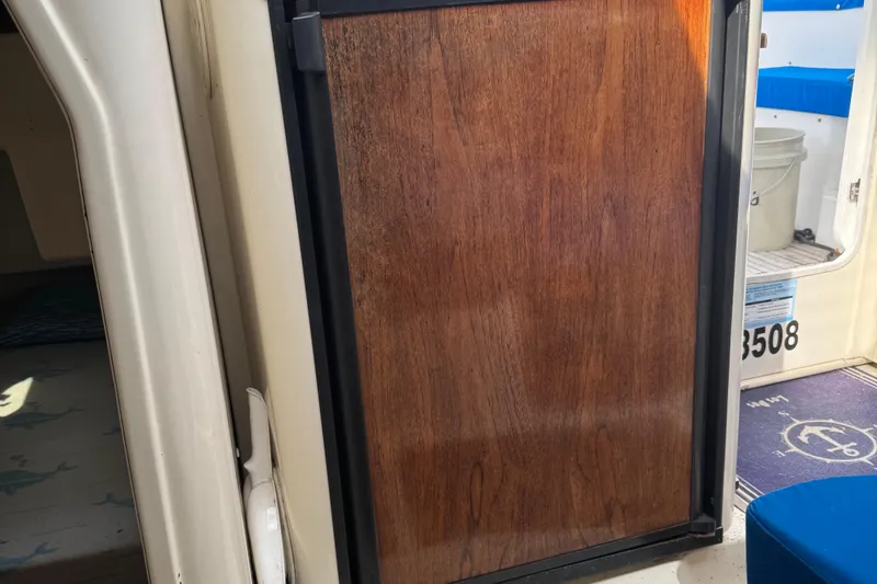 Slide: The Image of Wooden cabin door on a 2008 Gemini 105Mc boat interior. - 24